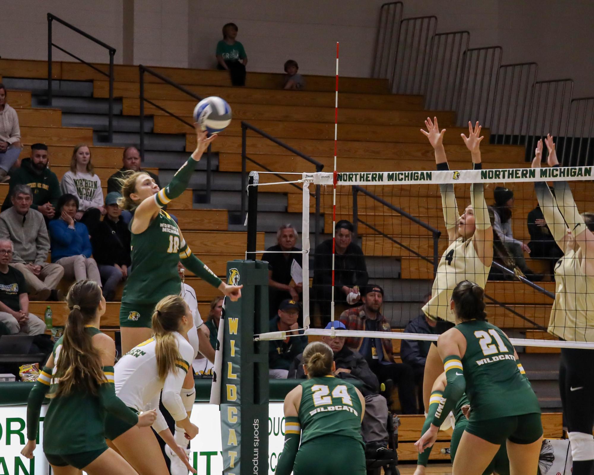 CATCHING FIRE — Jacqueline Smith (10) getting over the net for a point over two defenders. After a rough start to the season and some key injuries, the Wildcats have gone 4-2 in their last six games.