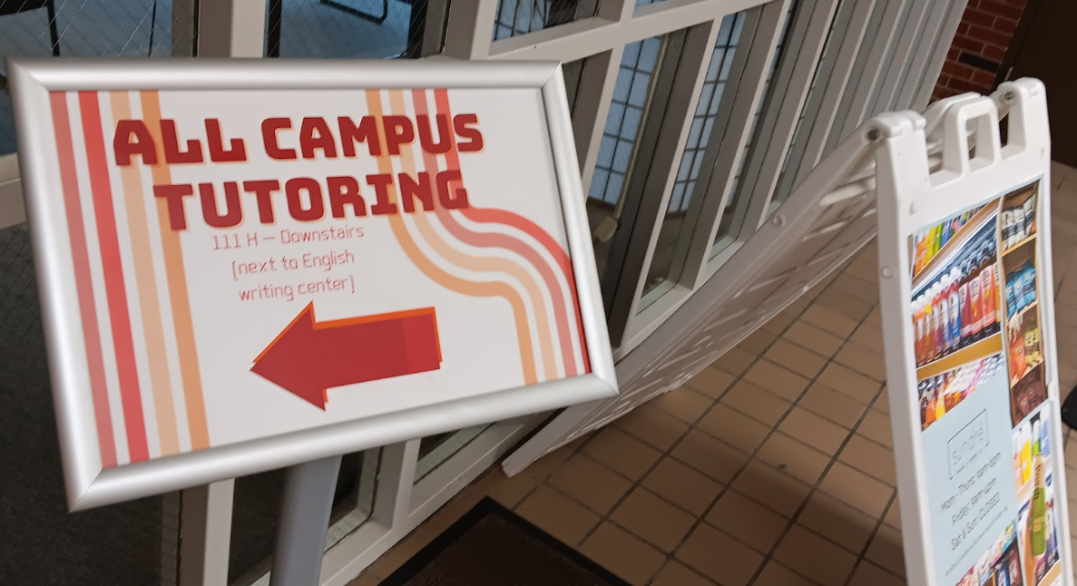 EXTRA HELP — A sign pointing to campus tutoring. Sometimes a little time with a tutor is what we need to understand the material and land a better grade.