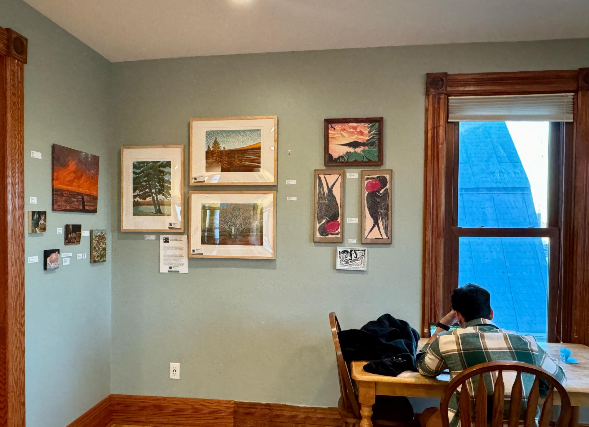 LOCAL ART — Art hung on all the walls in The Crib so people could admire and purchase it as they worked. 