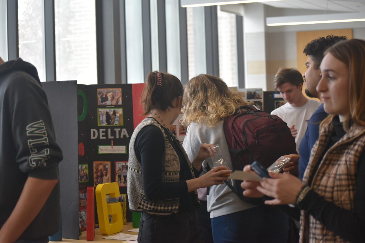 MANY OPTIONS — Students examine different table setups from various organizations around campus. 