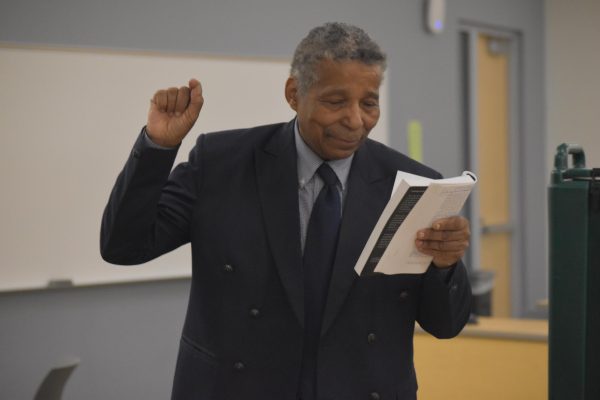 STRONG WORDS — Dr. Carter Wilson reads from a book discussing critical race theory at his speech on the subject.