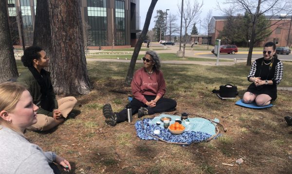 SHINRIN-YOKU — Jacquie Medina sits with students at shinrin-yoku, also known as forest bathing, event to focus on the nature present around them in order to relax.