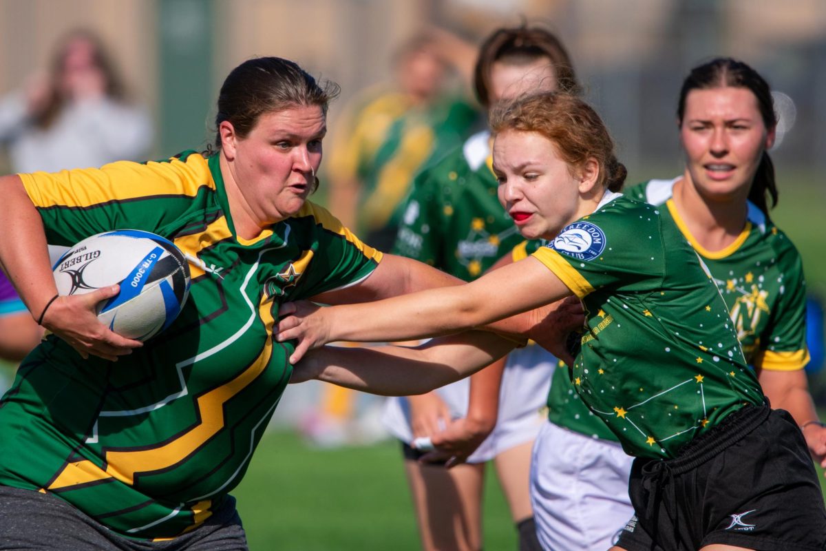 BATTLE FOR THE BALL - Alumni team members play rough and ready during Saturday's annual Alumni Rugby game. 