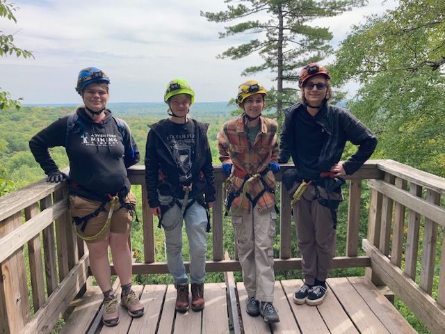 ADVENTURE- Four members of the club are suited up in climbing gear, ready to explore the local copper mines. Photo courtesy of Aura Wahl-Piotrowski