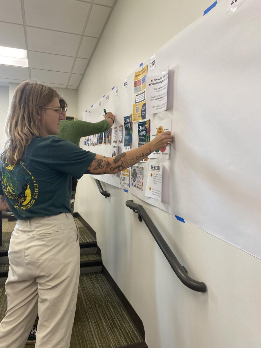 TEAM UP - Students and community members work together to give feedback on past and future events held by the Northern Climate Network by writing their ideas on interactive timelines. 