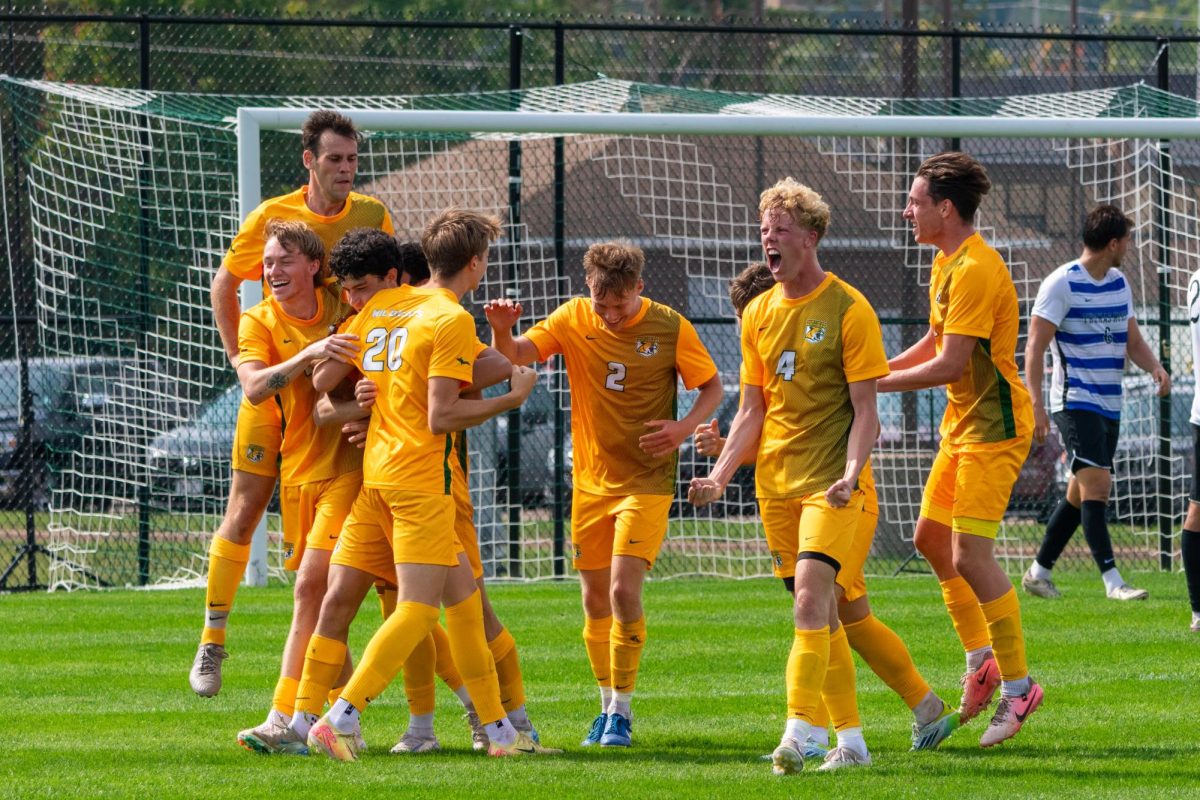 WILDCAT GOAL — The Men's Soccer team celebrates after a goal. 