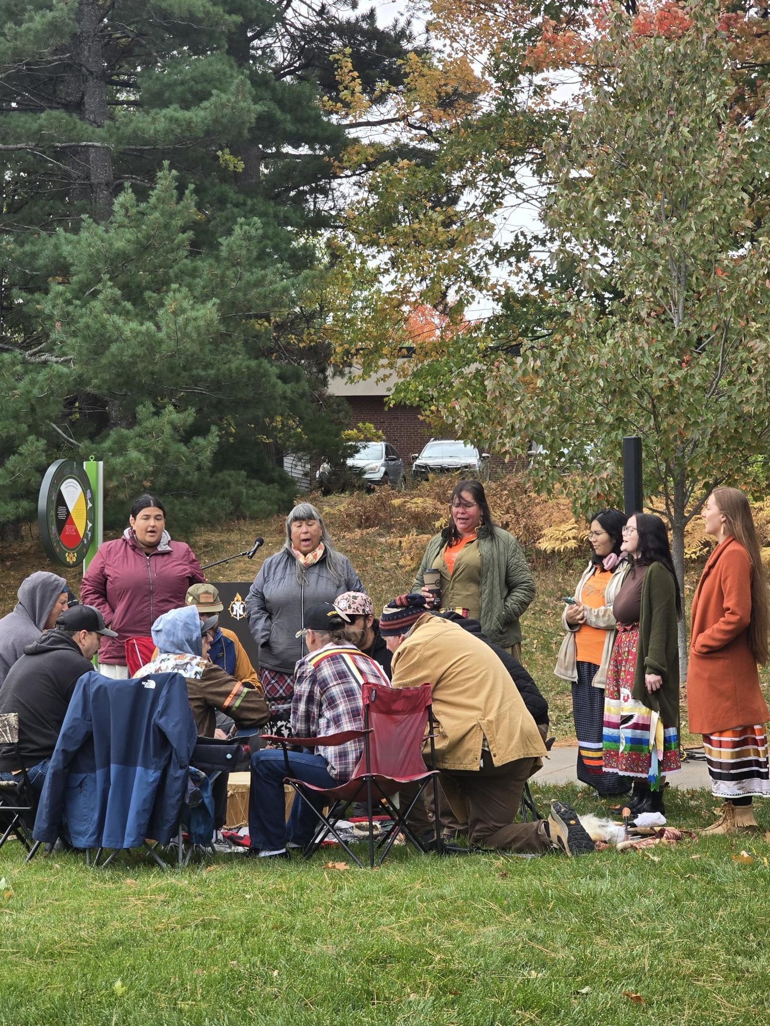 WELCOMING THE DAY - The Teal Lake Singers gather around the drum to celebrate the day.