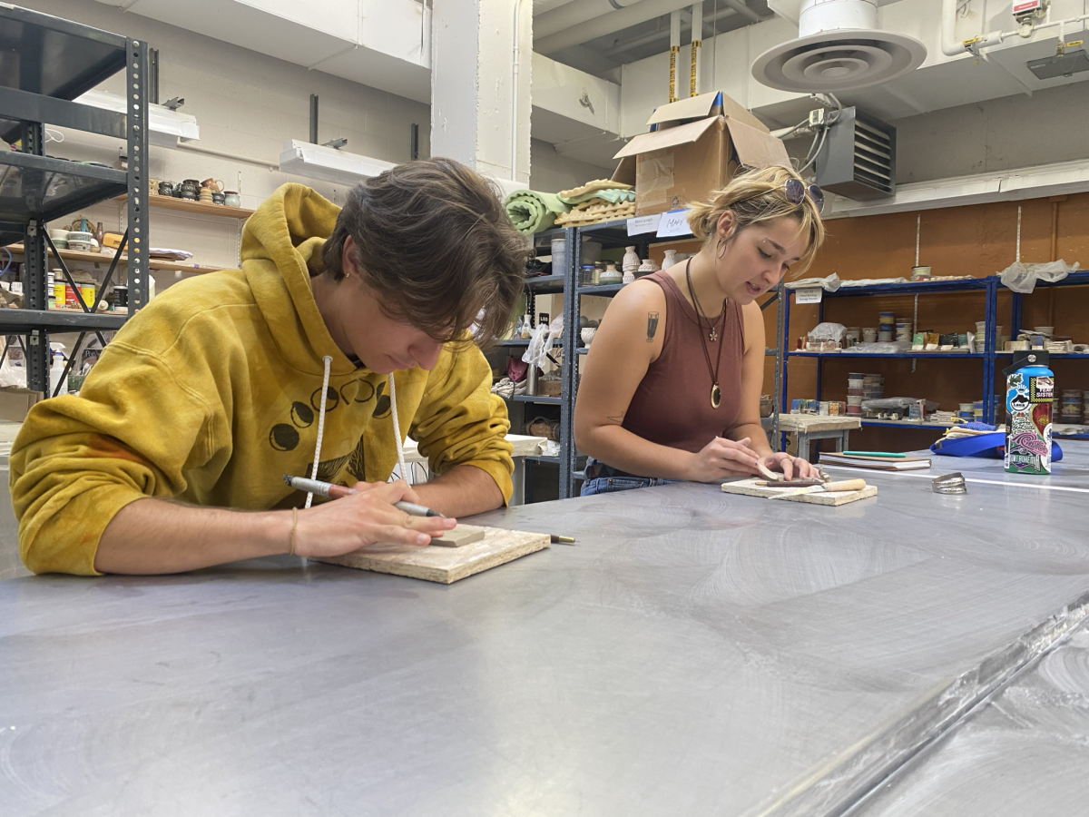 BRAINSTORM - Two students carefully design their sprigs that will be placed on Wildcat Willy’s shirt during the first of several workshops with artist George Rodriguez. 