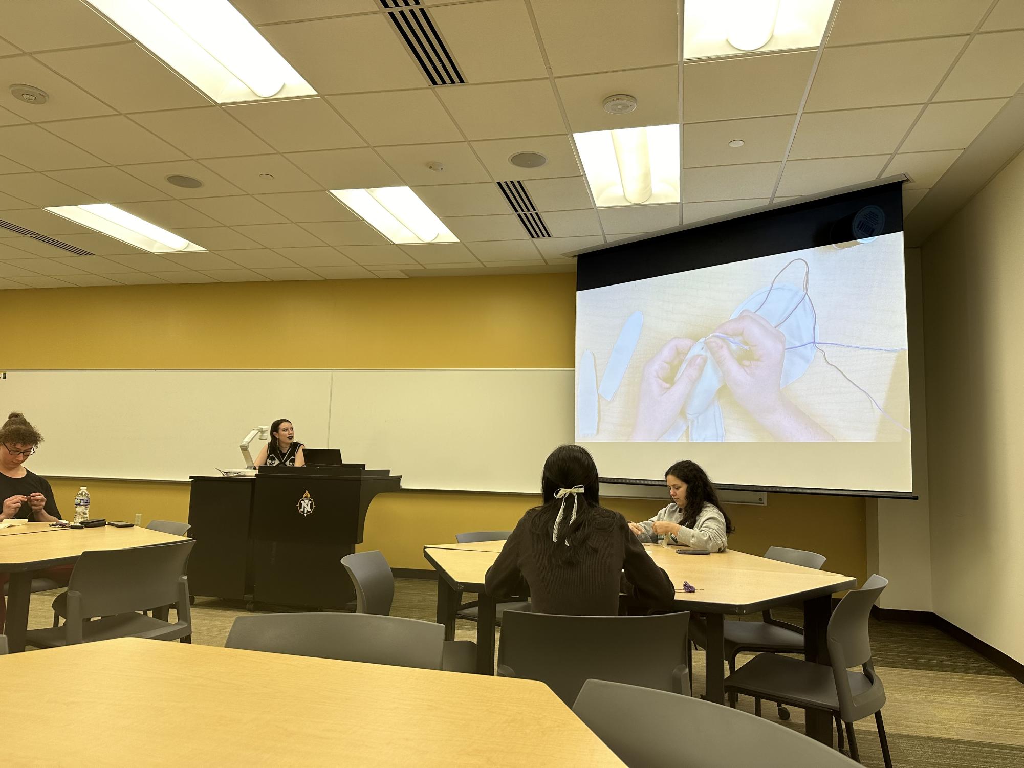 A STITCH IN TIME - President of Feminism for All Lindsey Herron shows students how to sew running and overcast stiches. 