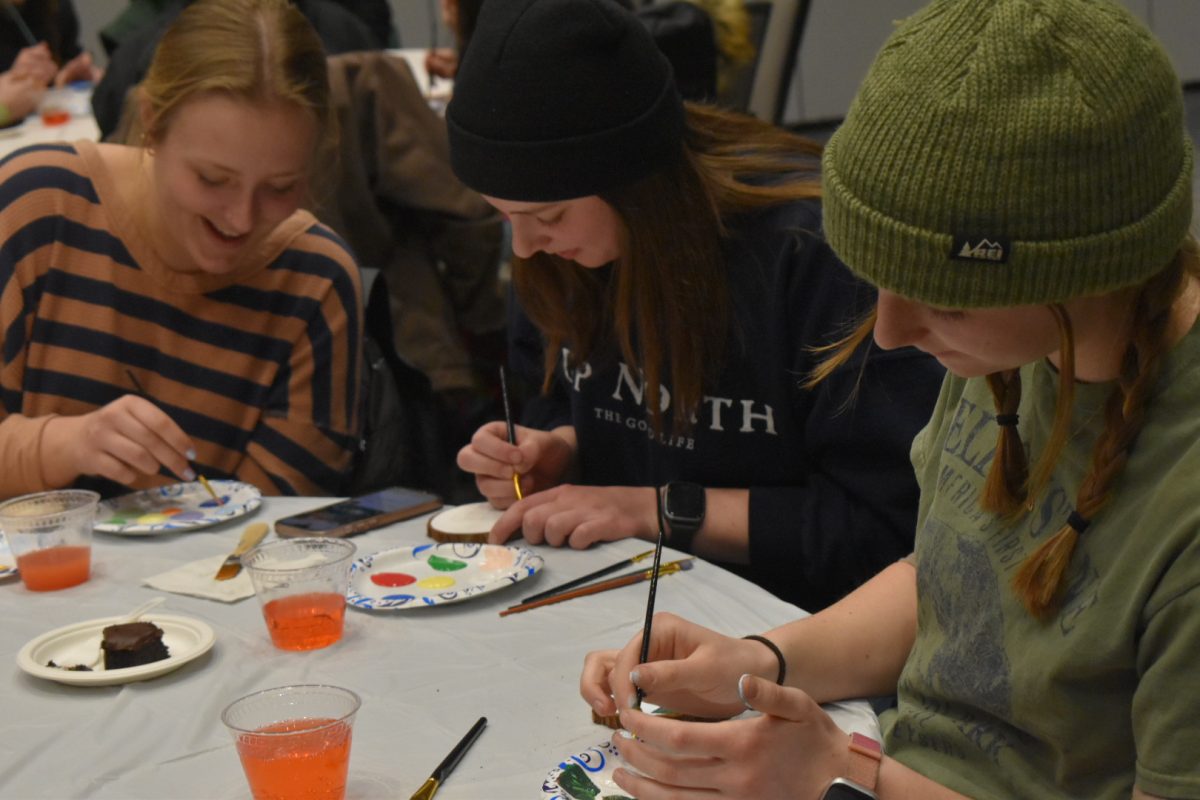 STOP AND PAINT —Students paint their logs as a way to relax throughout the busy time of year.