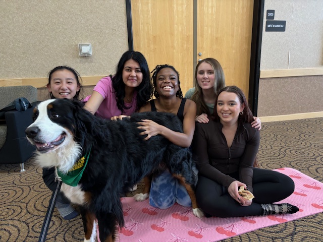 POSE - Participants smile with NMU's Wildpup Moon. 