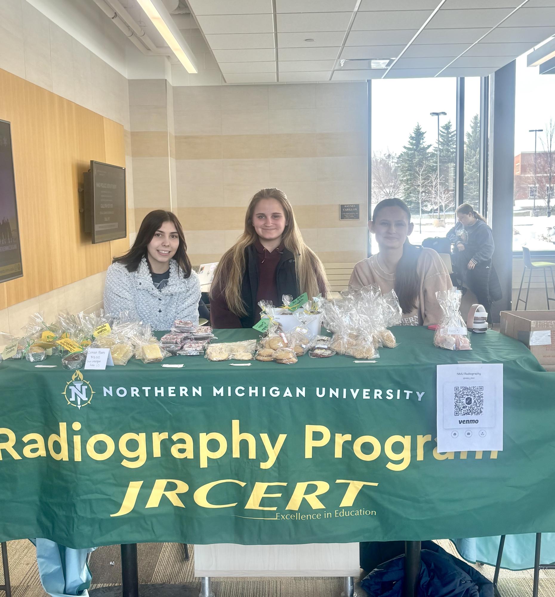 SAY CHEESE — Radiography students work the bake sale to raise money for their program. 
