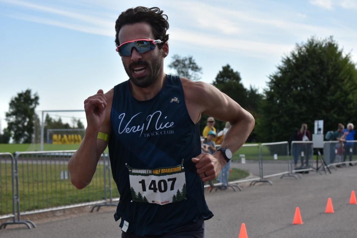 ON THE RUN — A racer grimaces as he sprints through the finish chute.