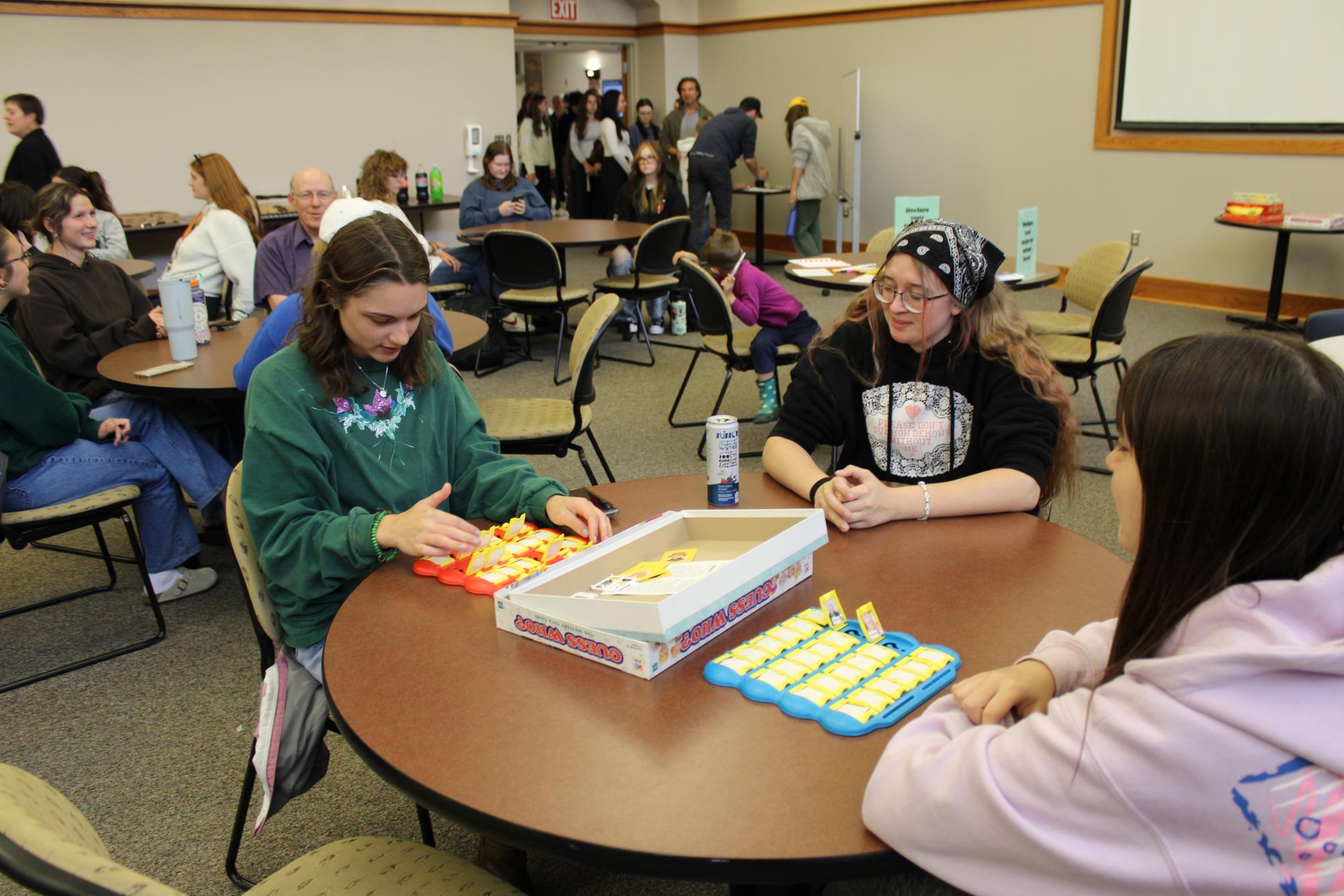 GAME ON—  Students enjoy a game of Guess Who with fellow members of the LLIS department. 