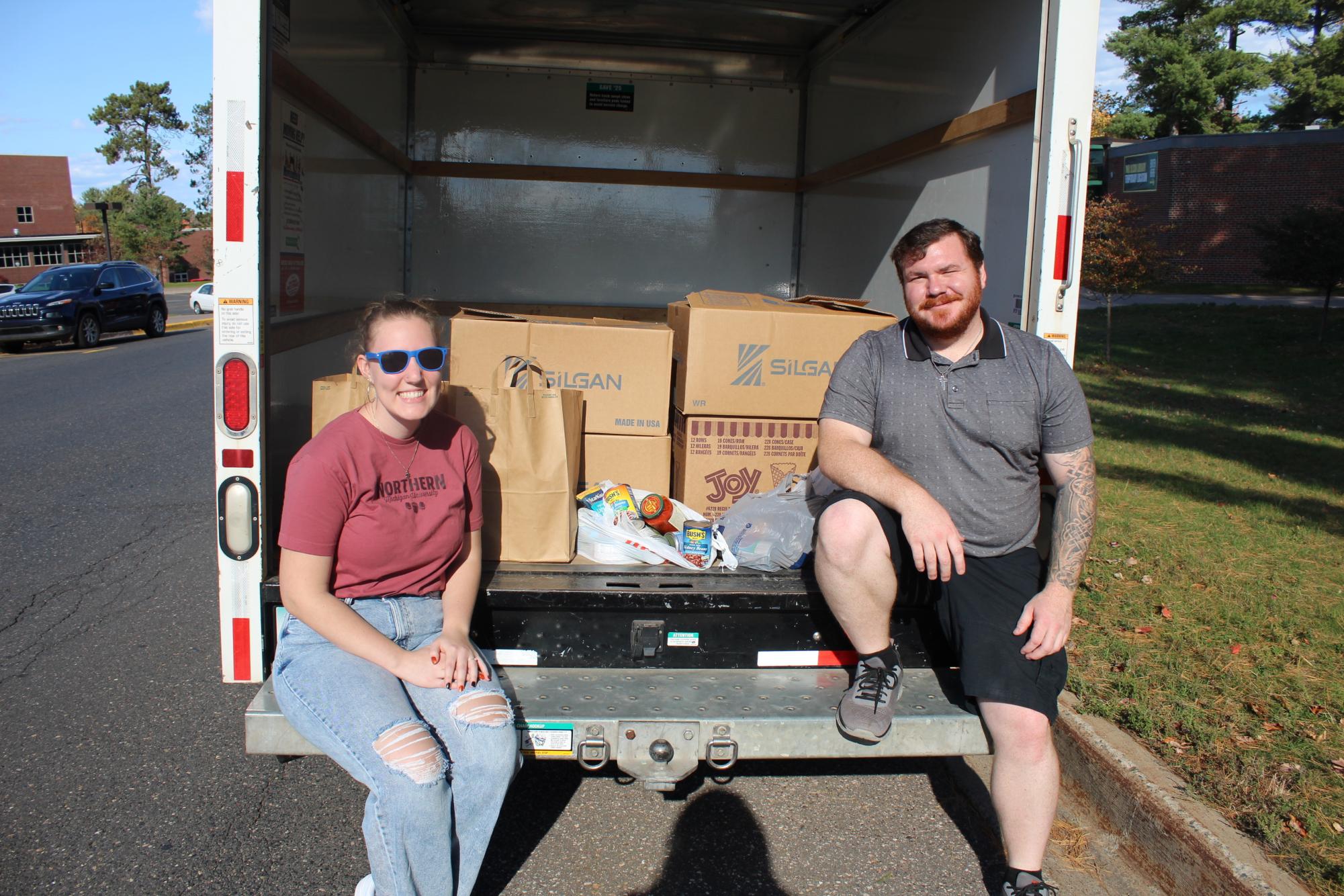 WORKING TOGETHER- Students from the NMU chapter of the Mortar Board National Honor Society collect canned goods.