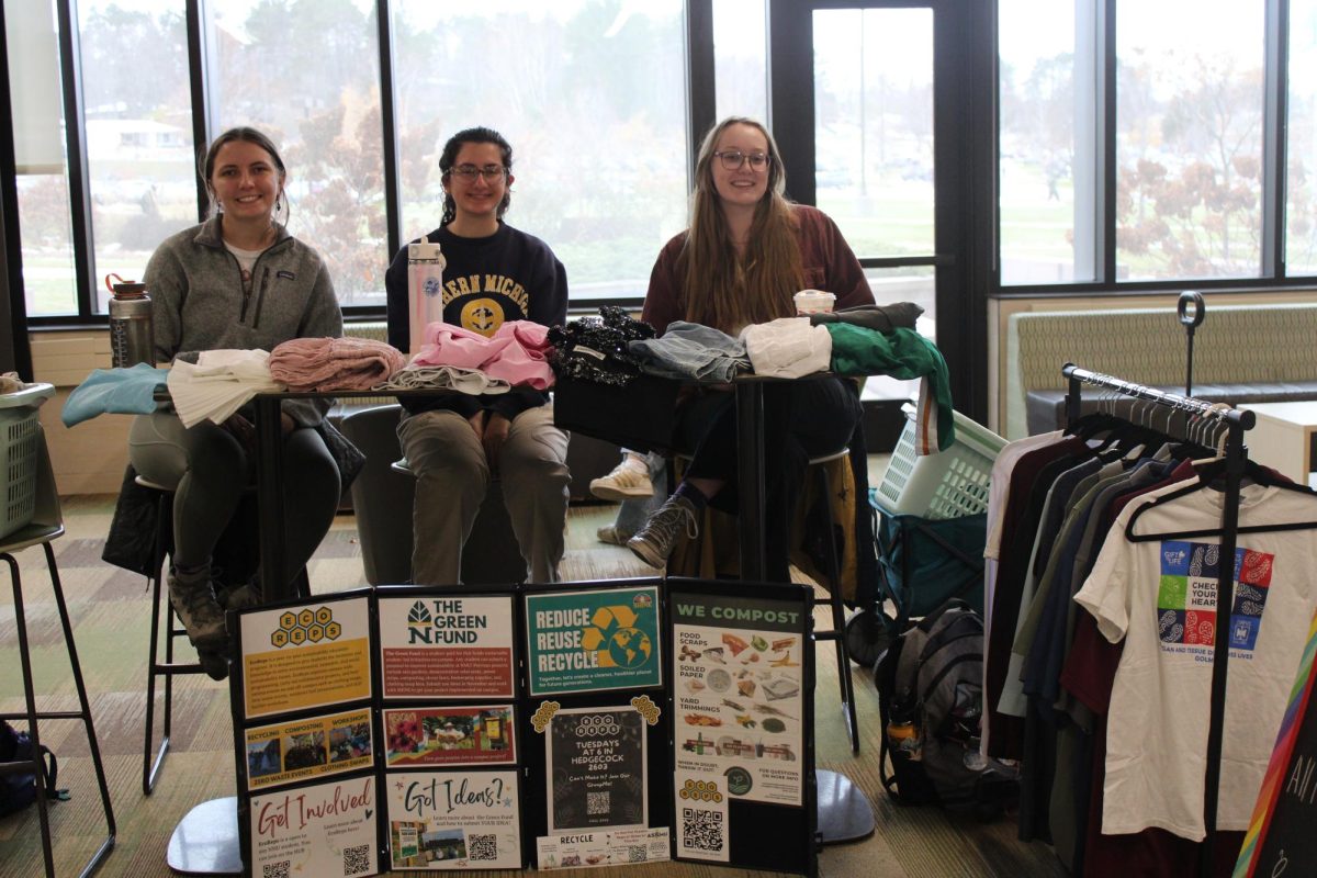 GETTING THRIFTY – EcoReps members set up racks full of clothes for students to browse during the clothing swap. 

