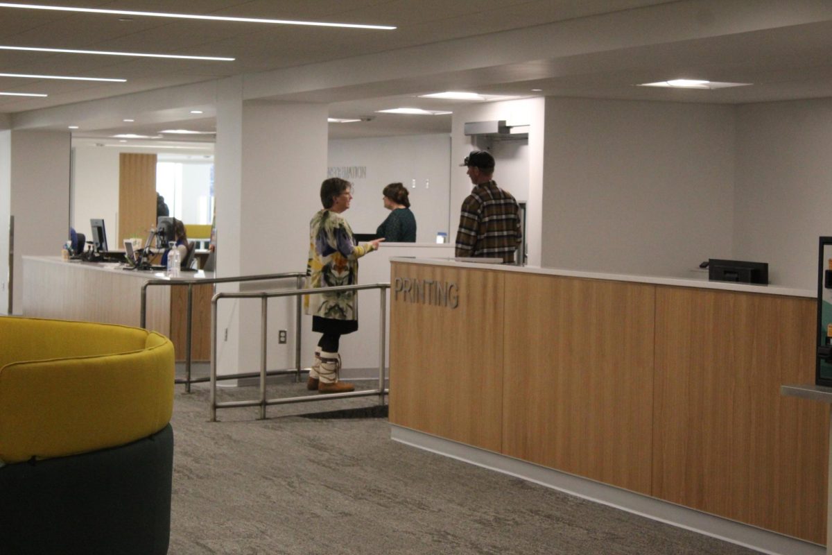 Dean of the Library, Leslie Warren, talks with Lydia M. Olson library staff on the first day of classes at NMU. 