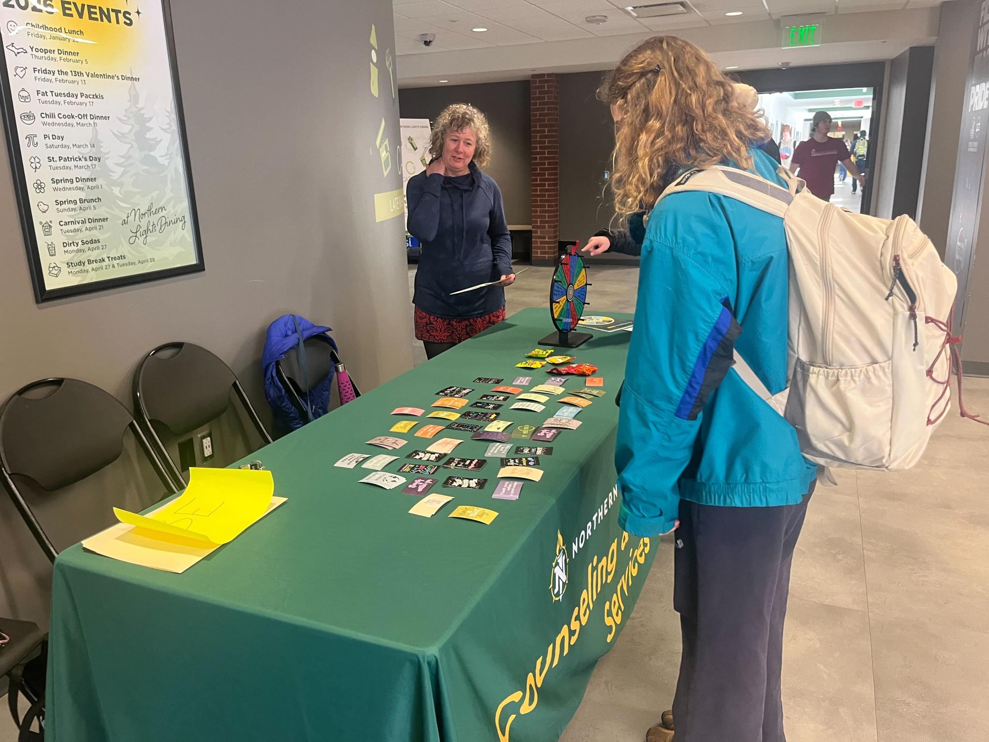 A student looks at the offerings for Kindness Week from WellBeing and Counseling and Consultation Services.