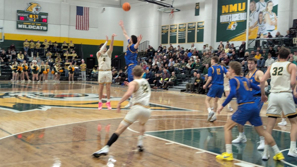 GREEN LIGHT - NMU lights up the scoreboard from behind the arc.