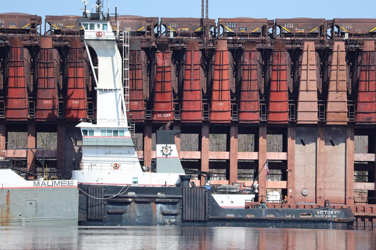 VICTORY— There she is, folks, the tugboat Victory! Designed to push barges through the lakes, she's just 39 meters long. 